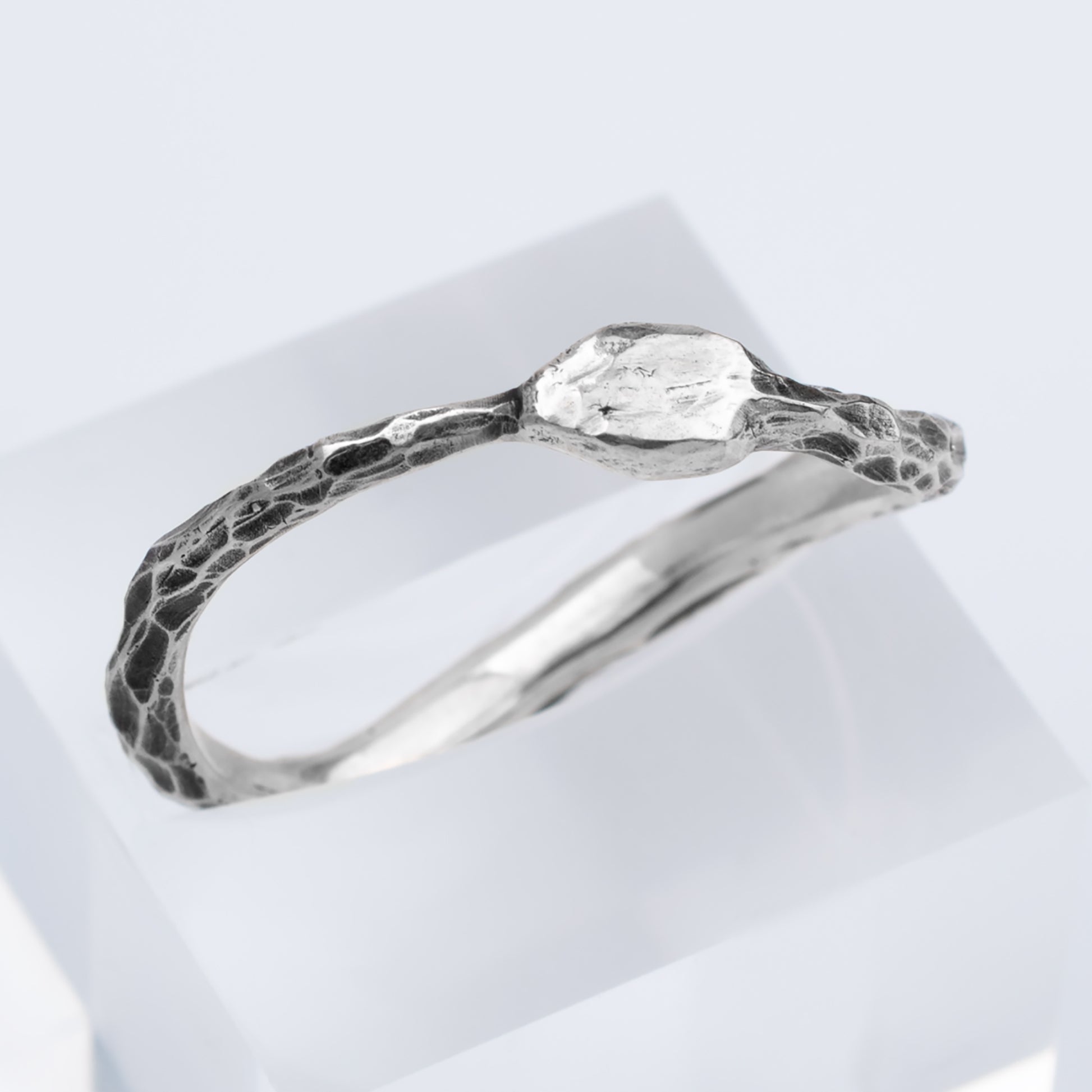 Silver ring with a textured band 