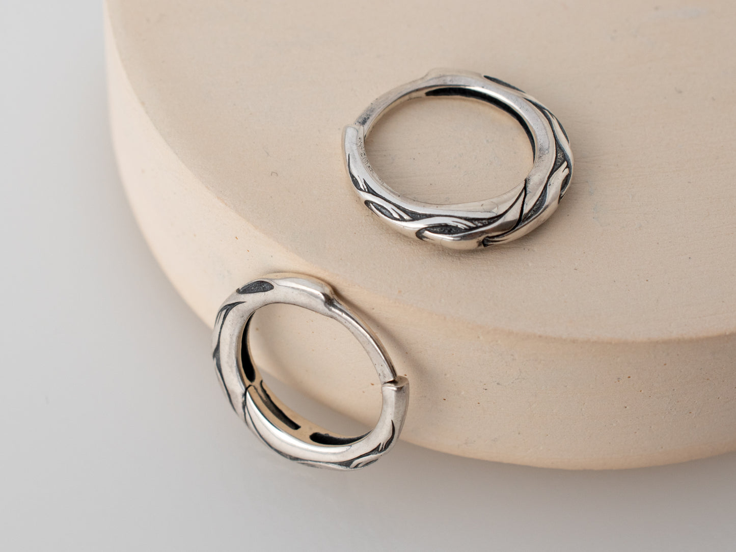 Silver hoop earrings with waved unique ornament for men or women