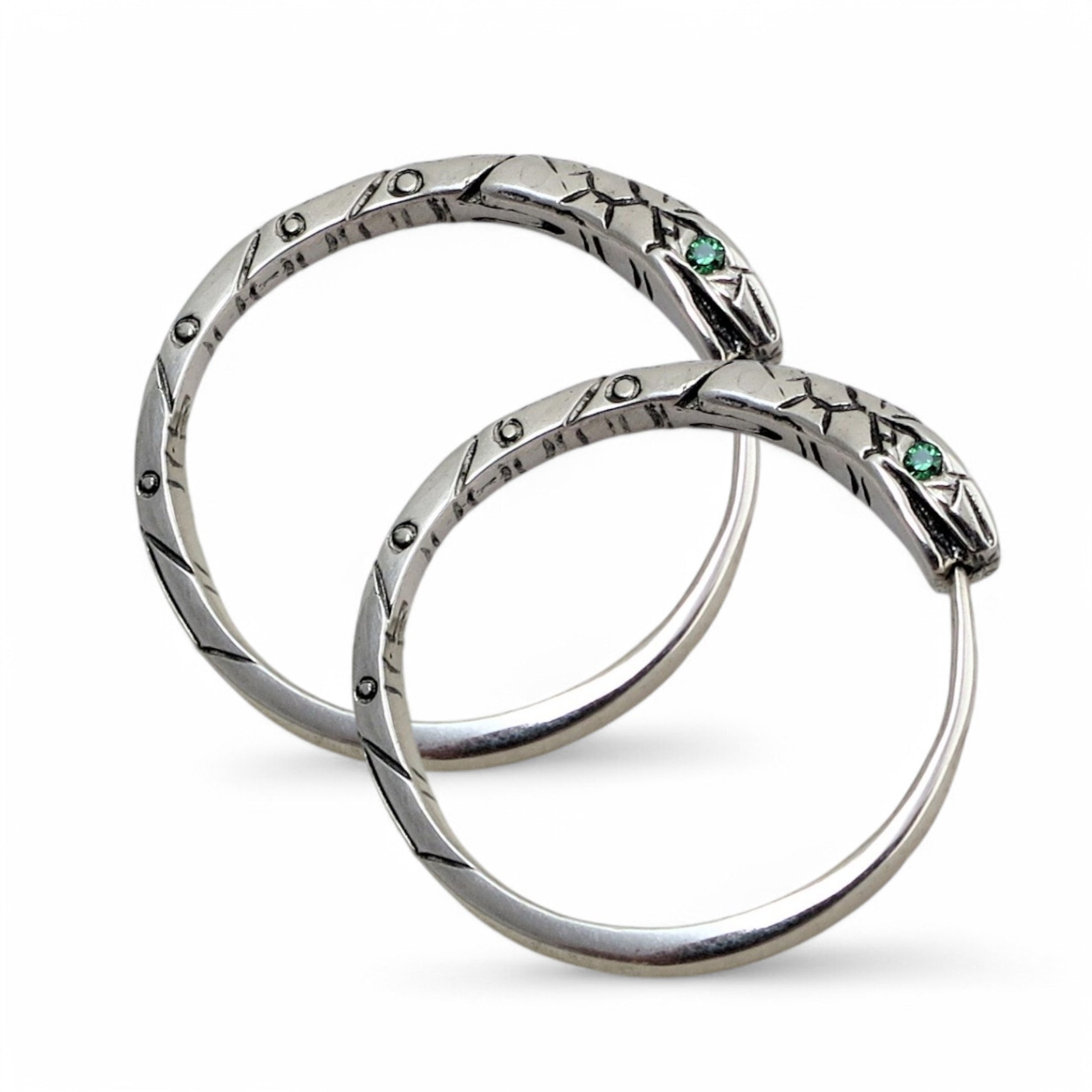 large silver ouroboros earring hinged hoop close up