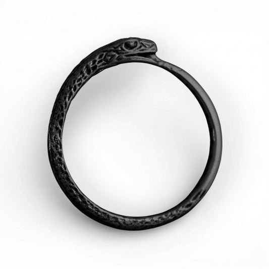 Black silver ring with intricate design on a white background