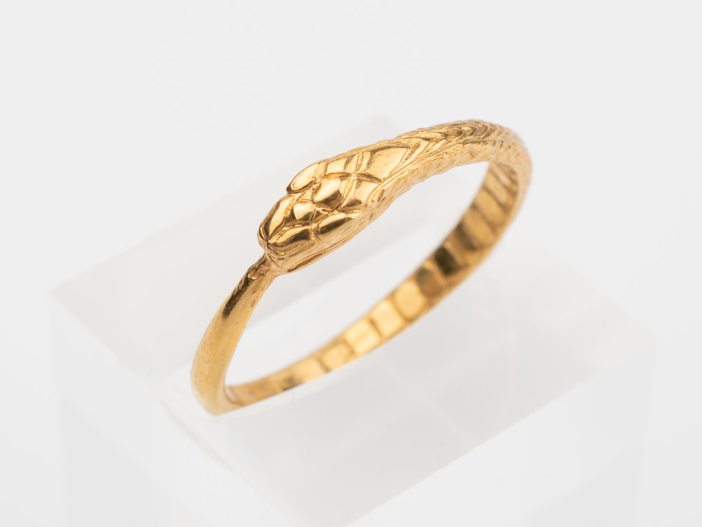 Gold ring with a snake head design